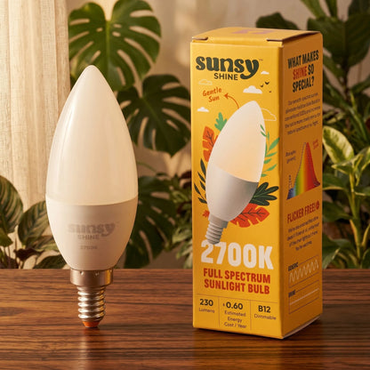 Sunny Shine light bulb and packaging on a wooden surface with plants in the background